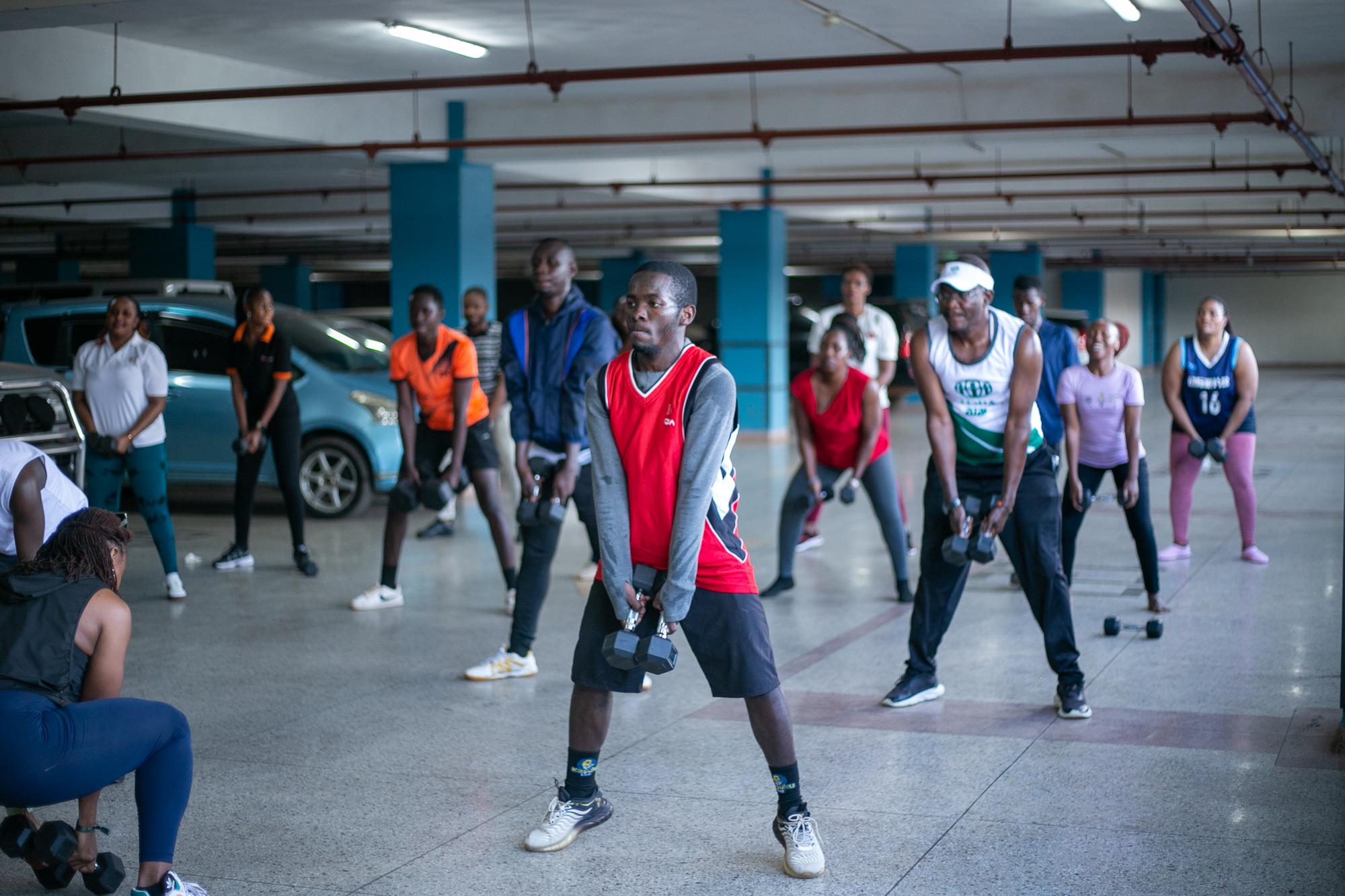 An MWH group class working with dumbbells